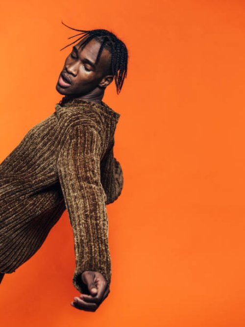 young man falling backwards in studio - hairstyle photos et images de collection
