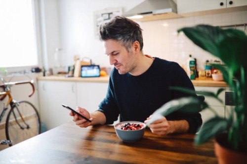 young man having a healthy breakfast - food stock pictures, royalty-free photos & images