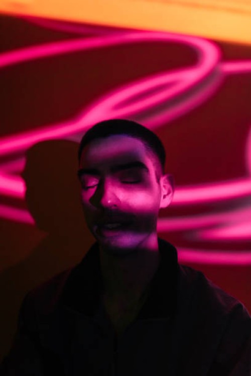 young man illuminated by neon lights - fashion stock pictures, royalty-free photos & images