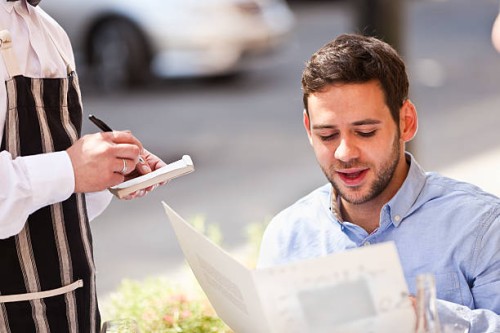 young man in restarant cafe - food stock pictures, royalty-free photos & images
