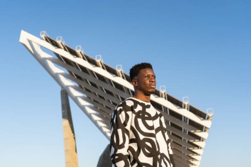 young man portrait looking horizon against blue sky at sunset - fashion stock pictures, royalty-free photos & images