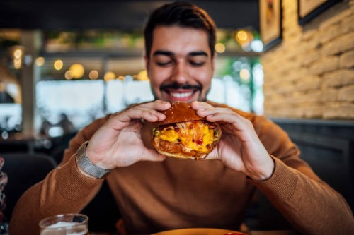 young man ready to eat a burger - food stock pictures, royalty-free photos & images