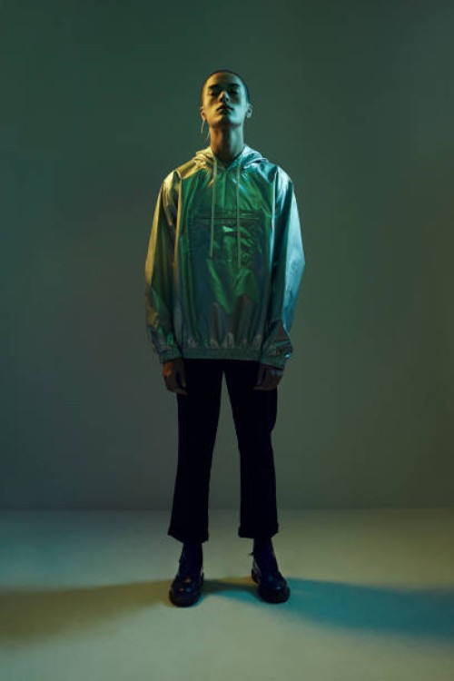 young man standing in coloured lights with closed eyes , shot on studio - fashion stock pictures, royalty-free photos & images