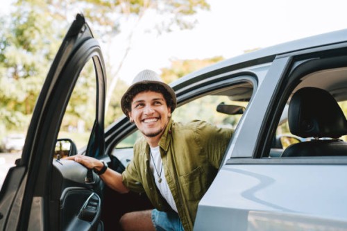 young man traveling by car getting out of the car - travel stock pictures, royalty-free photos & images