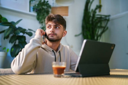 young man using digital tablet at the coffee shop - junk food stock pictures, royalty-free photos & images