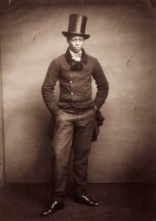 Young man wearing a formal suit and top hat.