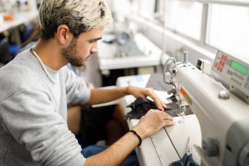 young men using a sewing machine - fashion stock pictures, royalty-free photos & images