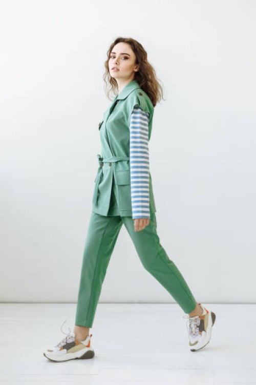 young model woman walking against white wall background in studio - fashion stock pictures, royalty-free photos & images