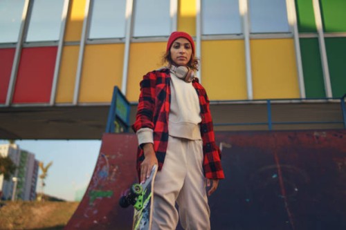 young modern woman outdoors in the city, with skateboard. - fashion stock pictures, royalty-free photos & images