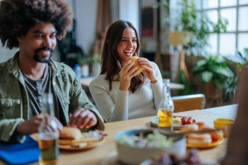 young people enjoying burgers and beer at home party - junk food stock pictures, royalty-free photos & images