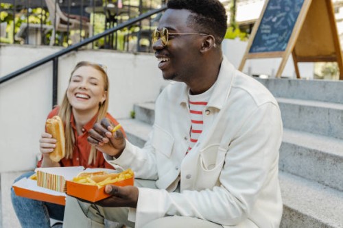 young people hang out and eat fast food on the street - junk food stock pictures, royalty-free photos & images