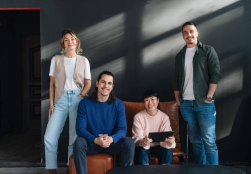young professionals in a modern co-working space together - fashion stock pictures, royalty-free photos & images