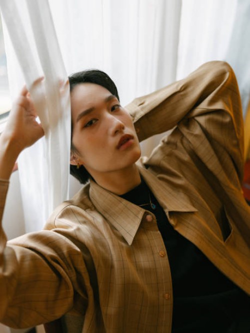 young stylish asian woman with short hair sitting and relaxing in western vintage style room or cafe indoors in daytime - fashion stock pictures, royalty-free photos & images