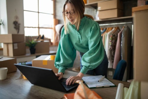 young woman accepting new orders in her e-commerce fashion store - fashion stock pictures, royalty-free photos & images