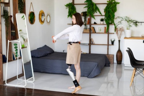 young woman amputee with prosthesis trying on new clothes at home - fashion stock pictures, royalty-free photos & images