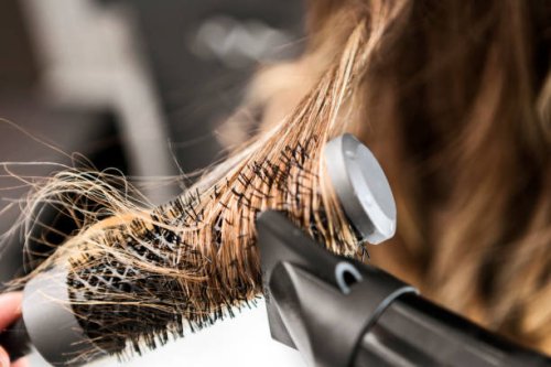 young woman at a hair salon ,hairdresser using hairdryer - hairstyle stock pictures, royalty-free photos & images