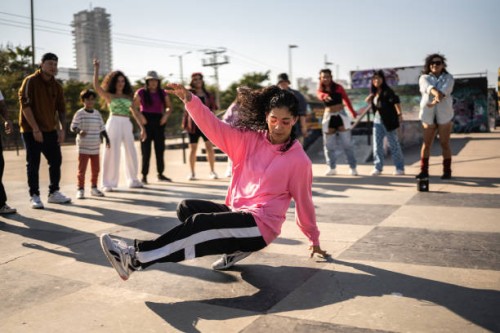 young woman breakdancing during street party with her friends outdoors - concert stock pictures, royalty-free photos & images