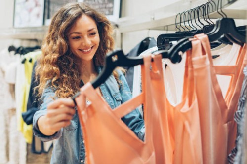 young woman browsing in the fashion store - fashion stock pictures, royalty-free photos & images