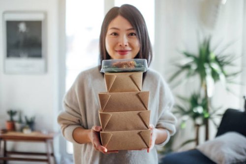 young woman carrying takeaway food boxes - junk food stock pictures, royalty-free photos & images
