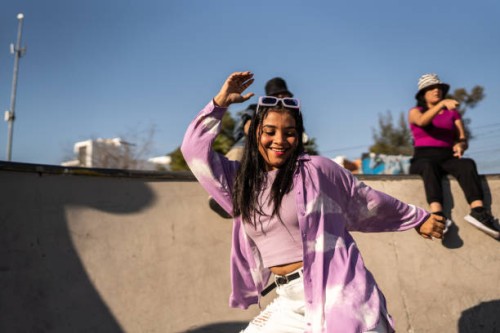young woman dancing and having fun during street party - fashion stock pictures, royalty-free photos & images