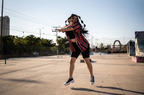 young woman dancing reggaeton at skateboard park - fashion stock pictures, royalty-free photos & images