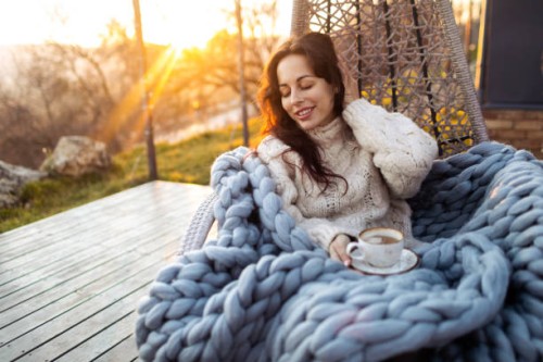 young woman drinking coffee at the beautiful terrace in the swing chair. - garden decoration photos et images de collection
