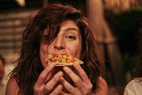 young woman eating food at bar - food stock pictures, royalty-free photos & images