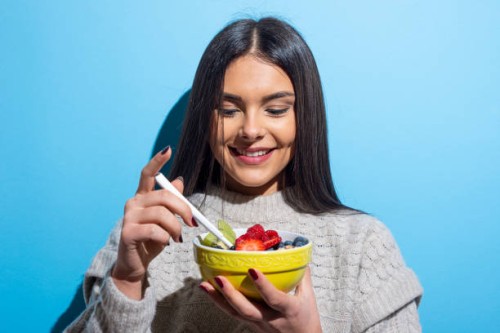 young woman eating muesli breakfast - food stock pictures, royalty-free photos & images
