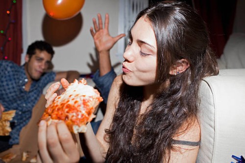 young woman eating pizza - junk food stock pictures, royalty-free photos & images