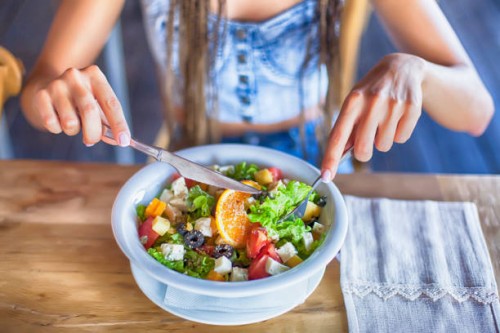 young woman eating salad for lunch - food stock pictures, royalty-free photos & images