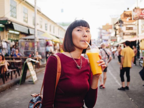 young woman enjoying mango juice in khao san road. bangkok, - junk food stock pictures, royalty-free photos & images