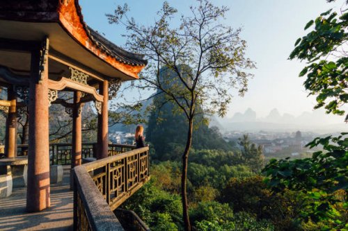 young woman enjoys view over yangshuo, karst mountains - travel stock pictures, royalty-free photos & images