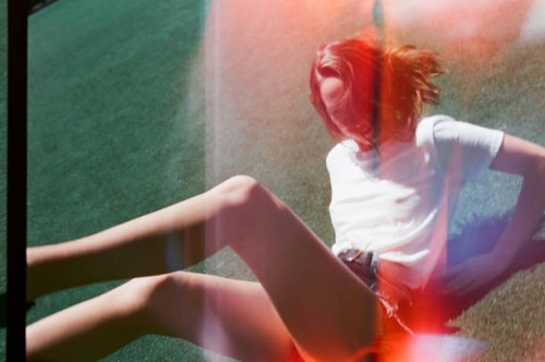 young woman falling backward and smiling in sports clothing - fashion stock pictures, royalty-free photos & images