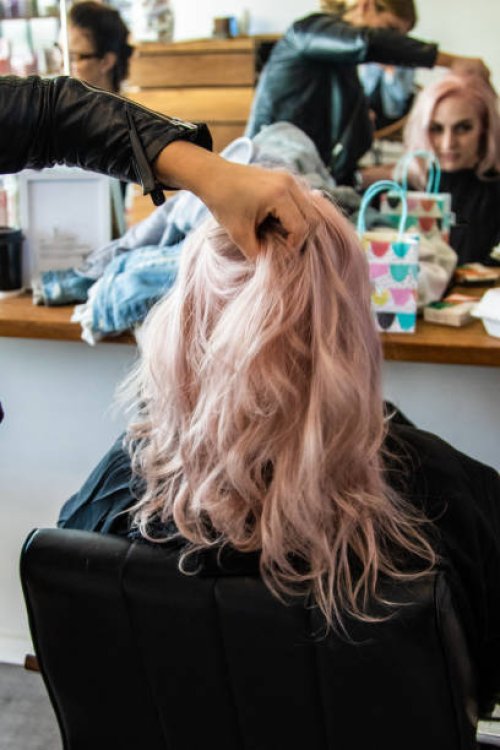 young woman having her hair done - hairstyle stock pictures, royalty-free photos & images