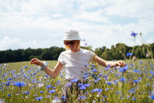 young woman in a sea of blue cornflowers - fashion stock pictures, royalty-free photos & images
