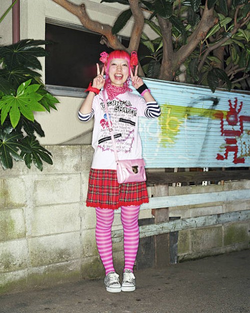 young woman making peace signs with hands, smiling, portrait - fashion stock pictures, royalty-free photos & images