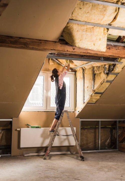young woman mounting insulation in her new home - home decoration stock pictures, royalty-free photos & images