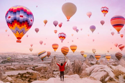 young woman on a background of flying balloons at sunrise in cappadocia - travel stock pictures, royalty-free photos & images