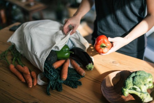 young woman organising groceries after shopping - food stock pictures, royalty-free photos & images