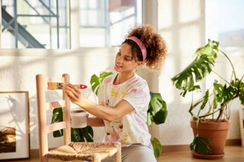 young woman painting chair at home - home decoration stock pictures, royalty-free photos & images