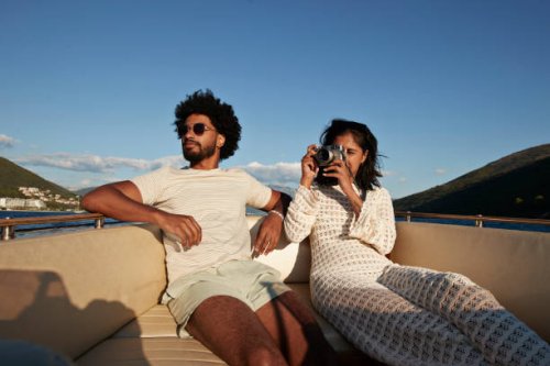 young woman photographing on camera by boyfriend - travel stock-fotos und bilder