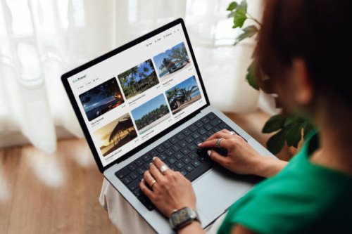 young woman planning a sustainable travel with laptop - travel stock pictures, royalty-free photos & images