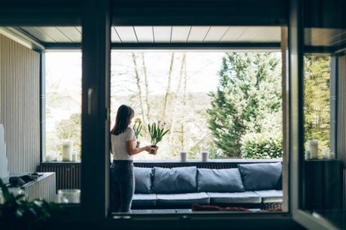 young woman planting freesias on her terasse in spring. - garden decoration stockfoto's en -beelden