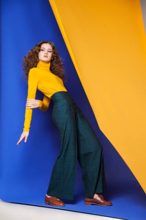 young woman posing on blue and yellow - fashion stock pictures, royalty-free photos & images