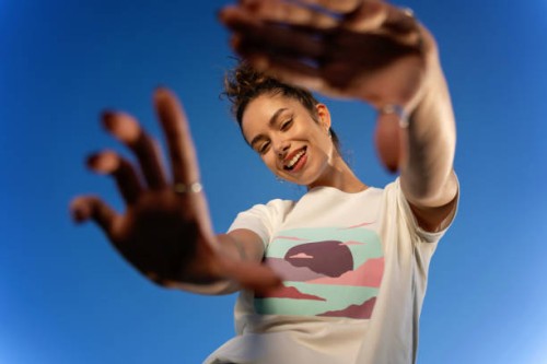 young woman posing outdoors against a clear blue sky, her fashionable attire shining under the natural light - fashion stock pictures, royalty-free photos & images