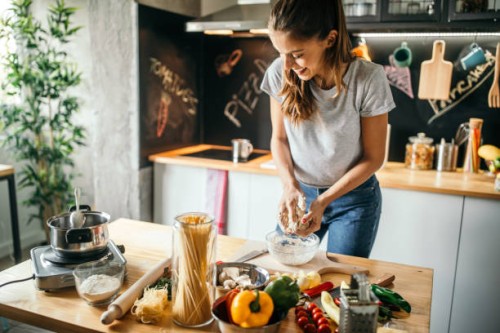 young woman preparing pizza - food stock pictures, royalty-free photos & images