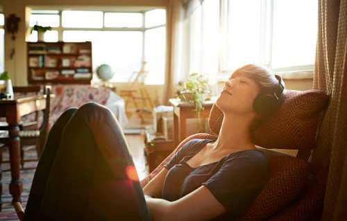 young woman relaxing with headphones at home - home decoration stock pictures, royalty-free photos & images