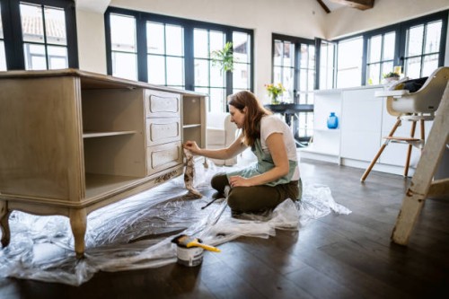 young woman repairing an old furniture and enjoying at home - home decoration stock pictures, royalty-free photos & images