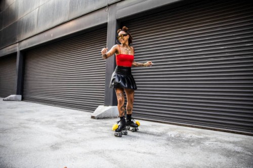 young woman rollerskating in urban area - fashion photos et images de collection