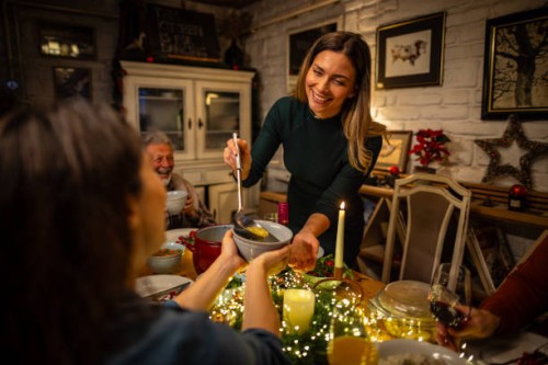 young woman serving a soup during the christmas dinner - food stock pictures, royalty-free photos & images